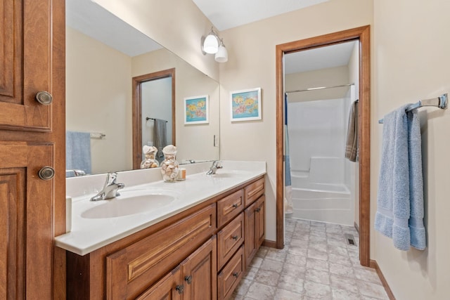 12800 Garrett Ct, Apple Valley, MN 55124 - bathroom featuring double vanity, stone finish floors, shower / bath combo with shower curtain, and baseboards