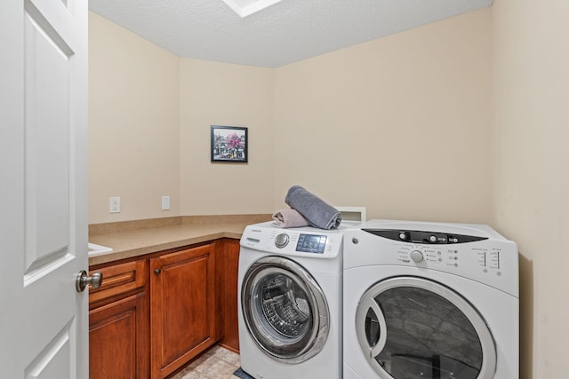 12800 Garrett Ct, Apple Valley, MN 55124 - washroom featuring washing machine and dryer, cabinet space, and a textured ceiling
