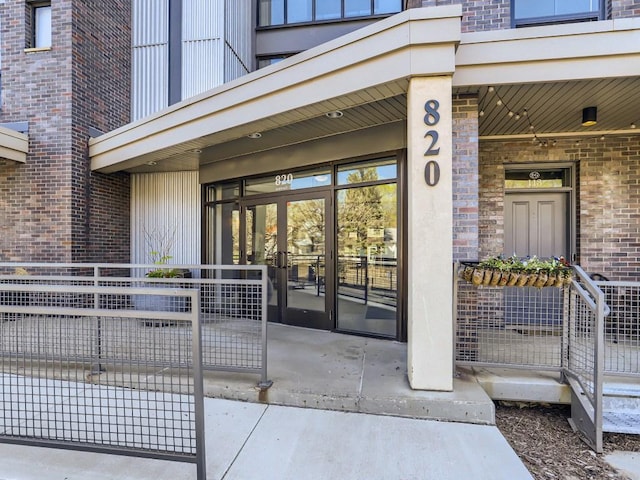 820 Emerald St Unit 402, Saint Paul, MN 55114 - doorway to property featuring brick siding and a porch