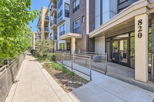 820 Emerald St Unit 402, Saint Paul, MN 55114 - entrance to property featuring brick siding, fence, and french doors