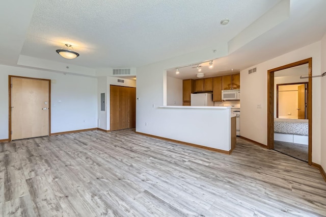 820 Emerald St Unit 402, Saint Paul, MN 55114 - unfurnished living room featuring baseboards, a textured ceiling, light wood finished floors, and rail lighting