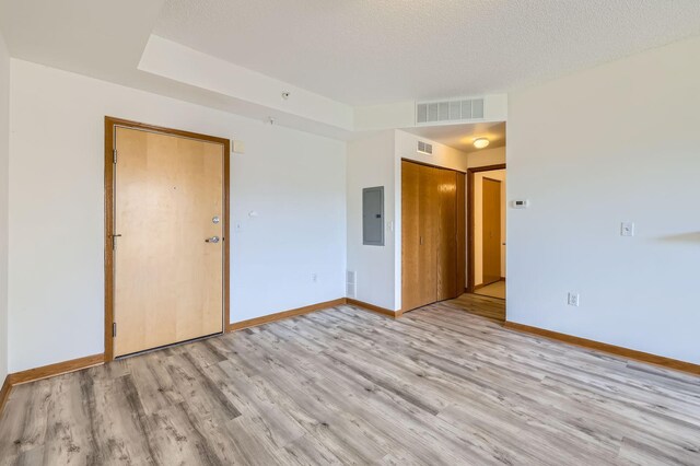 820 Emerald St Unit 402, Saint Paul, MN 55114 - spare room featuring electric panel, light wood-style flooring, baseboards, and a textured ceiling