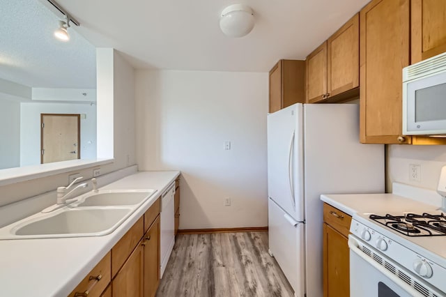 820 Emerald St Unit 402, Saint Paul, MN 55114 - kitchen featuring white appliances, a sink, light wood finished floors, light countertops, and track lighting