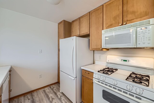 820 Emerald St Unit 402, Saint Paul, MN 55114 - kitchen featuring white appliances, light wood-style floors, light countertops, baseboards, and brown cabinets
