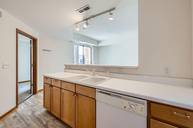 820 Emerald St Unit 402, Saint Paul, MN 55114 - kitchen with a sink, white dishwasher, light wood-style floors, light countertops, and rail lighting