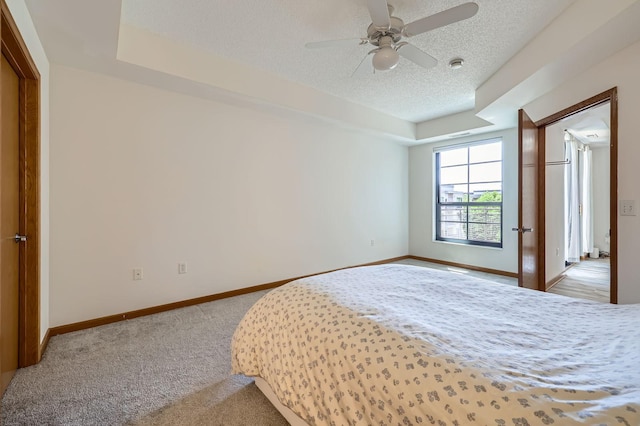 820 Emerald St Unit 402, Saint Paul, MN 55114 - bedroom featuring a textured ceiling, carpet floors, baseboards, and a ceiling fan