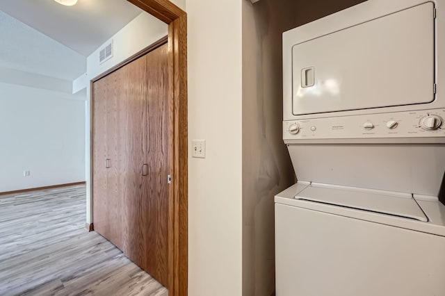 820 Emerald St Unit 402, Saint Paul, MN 55114 - washroom featuring stacked washer / drying machine and light wood-style floors