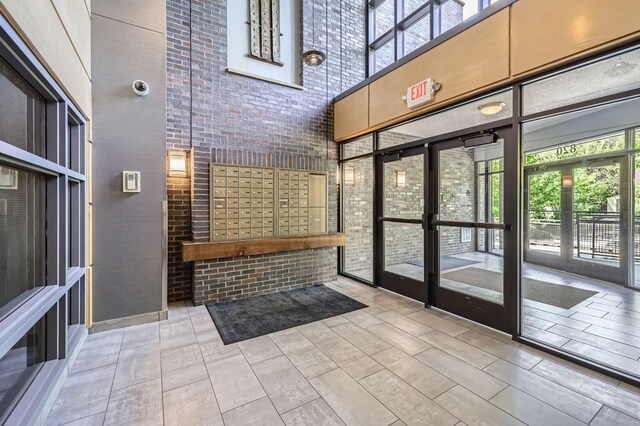 820 Emerald St Unit 402, Saint Paul, MN 55114 - community lobby featuring a high ceiling, brick wall, and a surveillance system