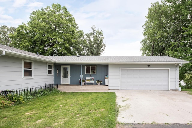 ranch-style house with driveway, fence, covered porch, a garage, and a front yard