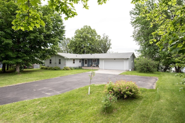 ranch-style home with an attached garage, driveway, and a front yard