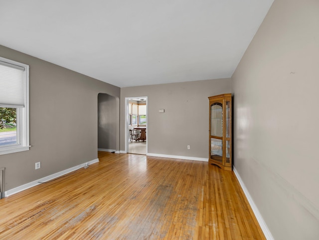 517 Olive St S, Waconia, MN 55387 - unfurnished room featuring arched walkways and wood-type flooring