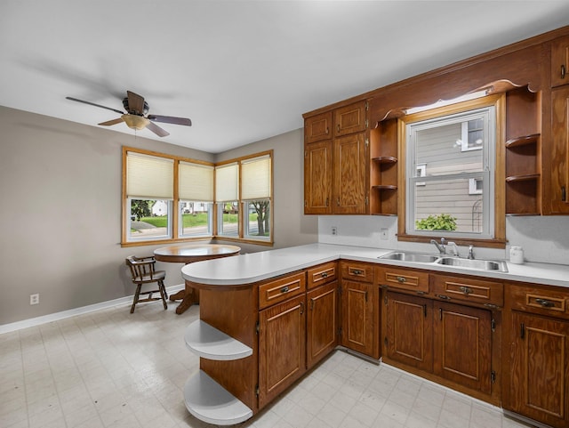 517 Olive St S, Waconia, MN 55387 - kitchen featuring open shelves, light countertops, ceiling fan, a peninsula, and light floors