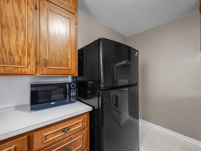 517 Olive St S, Waconia, MN 55387 - kitchen with black appliances, light countertops, and brown cabinetry