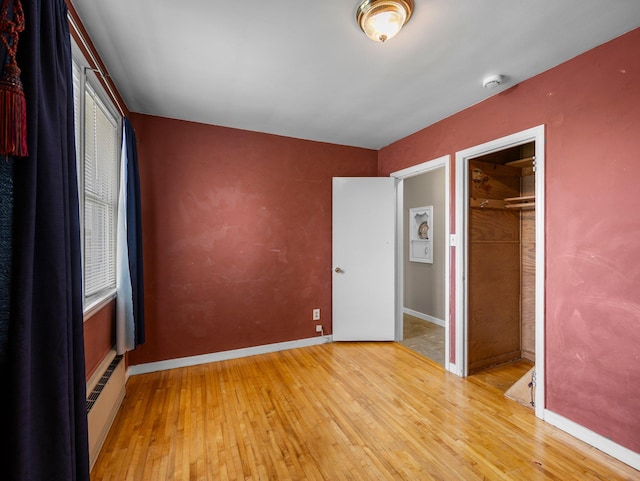517 Olive St S, Waconia, MN 55387 - unfurnished bedroom with light wood-style floors and a closet