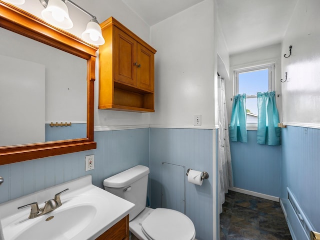 517 Olive St S, Waconia, MN 55387 - bathroom with vanity, a wainscoted wall, stone finish floors, and a shower with curtain