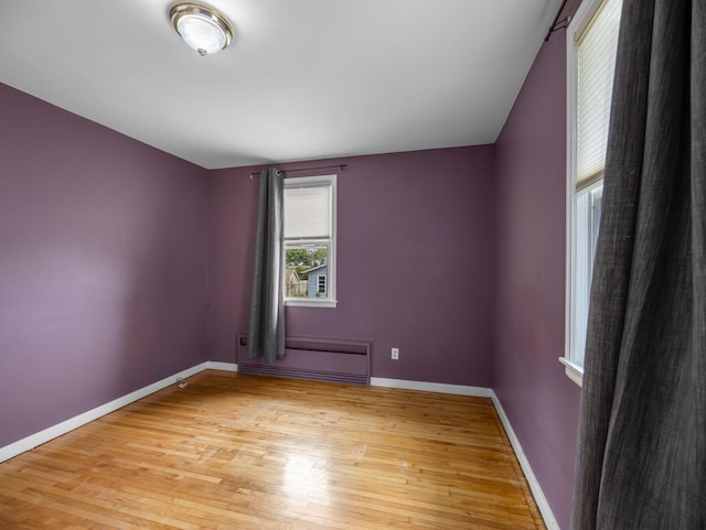517 Olive St S, Waconia, MN 55387 - spare room with a baseboard heating unit and light wood finished floors