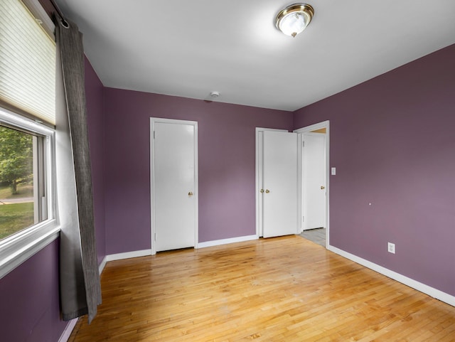 517 Olive St S, Waconia, MN 55387 - unfurnished bedroom featuring light wood-style floors