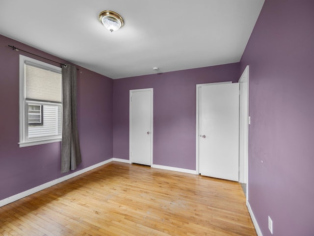 517 Olive St S, Waconia, MN 55387 - unfurnished bedroom with baseboards and light wood-type flooring