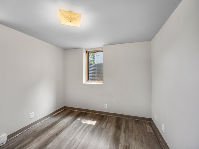 517 Olive St S, Waconia, MN 55387 - unfurnished room featuring wood finished floors and baseboard heating