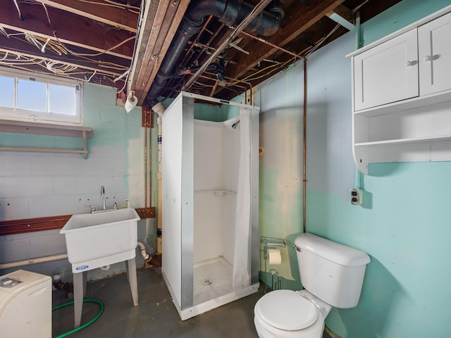 517 Olive St S, Waconia, MN 55387 - bathroom with concrete flooring, a shower stall, and concrete block wall