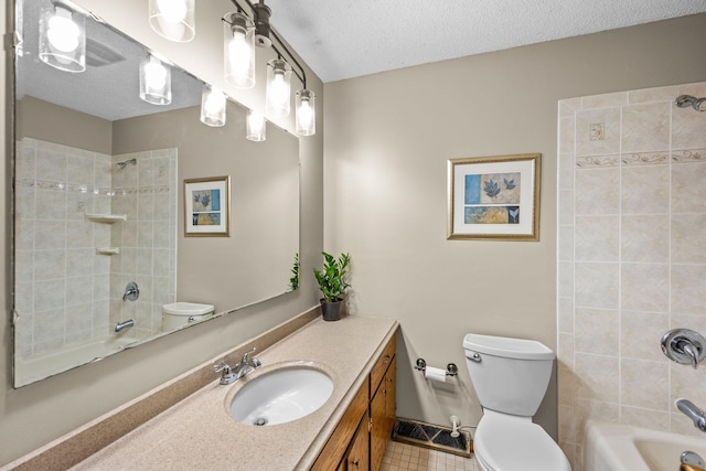 bathroom featuring toilet, tub / shower combination, a textured ceiling, vanity, and tile patterned floors