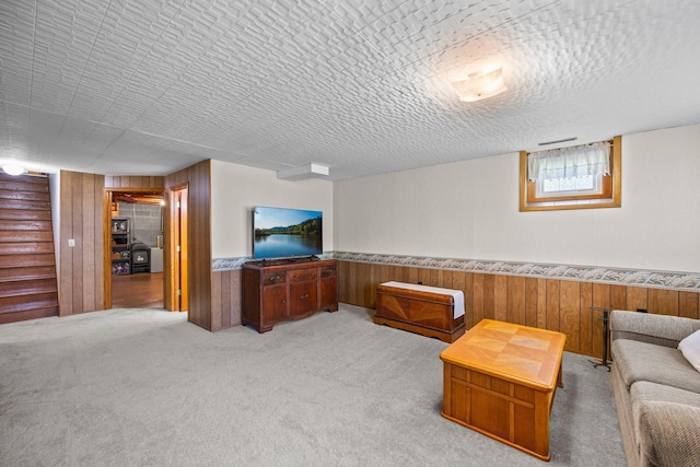 carpeted living room with wooden walls