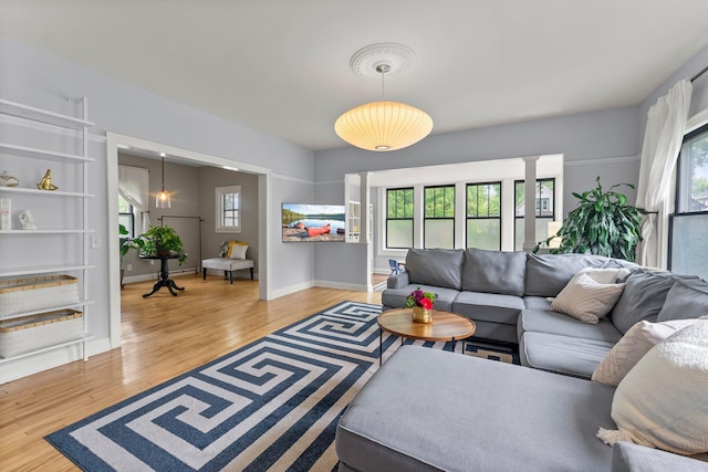 3100 29th Ave S, Minneapolis, MN 55406 - living area with light wood-type flooring, baseboards, and ornate columns