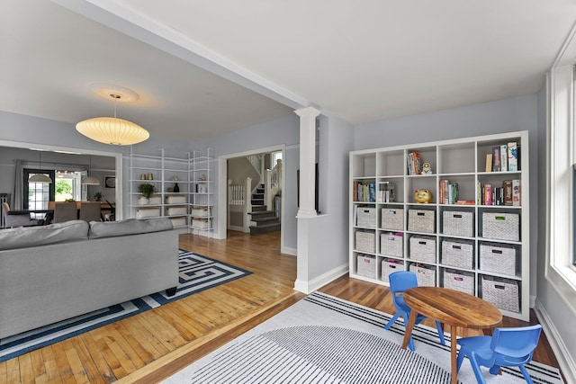 3100 29th Ave S, Minneapolis, MN 55406 - living area featuring wood finished floors, ornate columns, stairway, and baseboards