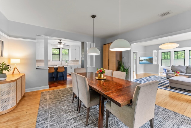 3100 29th Ave S, Minneapolis, MN 55406 - dining space featuring light wood-type flooring, baseboards, and ornate columns