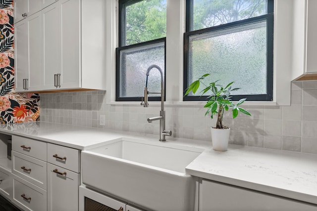 3100 29th Ave S, Minneapolis, MN 55406 - kitchen with a sink, tasteful backsplash, and white cabinets