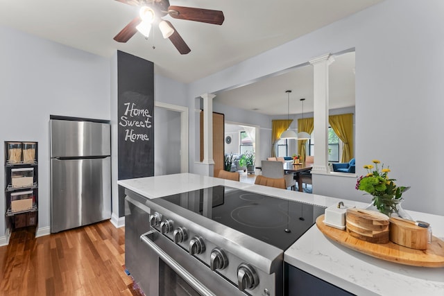 3100 29th Ave S, Minneapolis, MN 55406 - kitchen featuring ornate columns, stainless steel appliances, ceiling fan, and wood finished floors