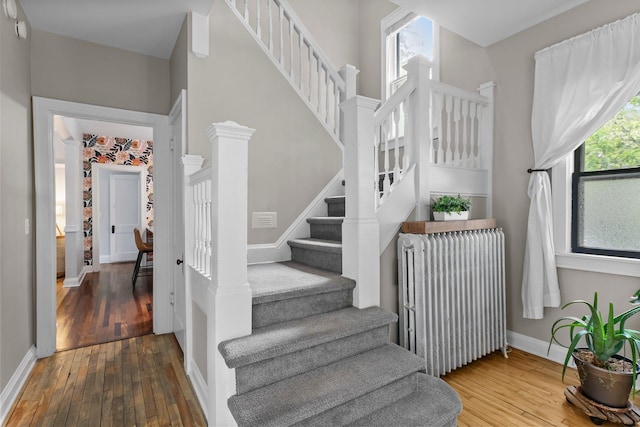 3100 29th Ave S, Minneapolis, MN 55406 - stairs featuring radiator heating unit, hardwood / wood-style flooring, and baseboards