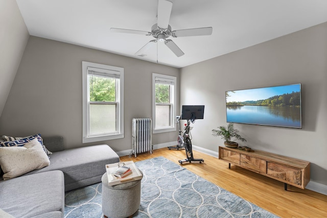 3100 29th Ave S, Minneapolis, MN 55406 - living room featuring radiator, a ceiling fan, wood finished floors, and baseboards