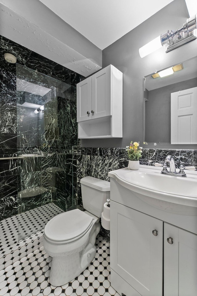 3100 29th Ave S, Minneapolis, MN 55406 - bathroom featuring a marble finish shower, vanity, toilet, and tile walls