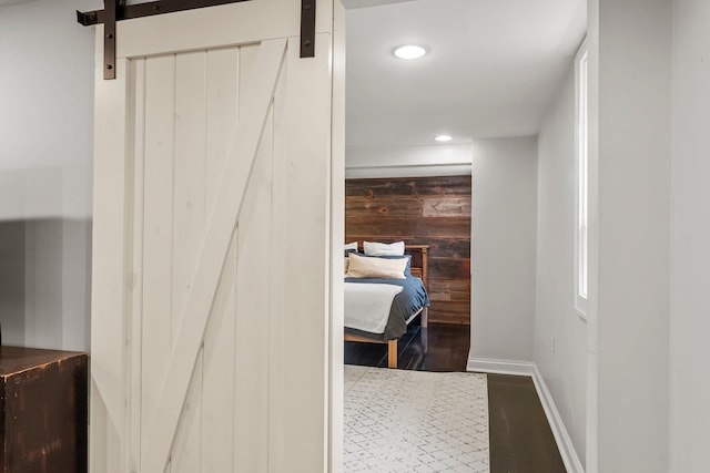 3100 29th Ave S, Minneapolis, MN 55406 - corridor with wood walls, recessed lighting, dark wood-style floors, baseboards, and a barn door
