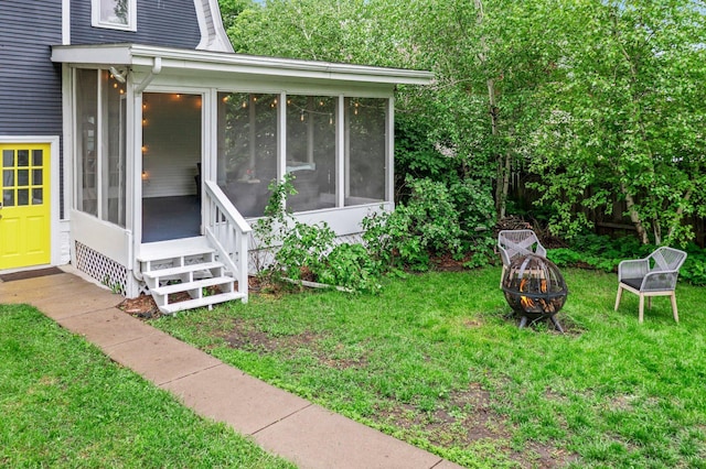 3100 29th Ave S, Minneapolis, MN 55406 - view of side of home with a sunroom, a fire pit, and a yard