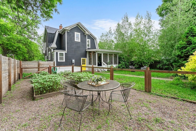 3100 29th Ave S, Minneapolis, MN 55406 - back of property featuring a sunroom, a gambrel roof, a chimney, and a shingled roof