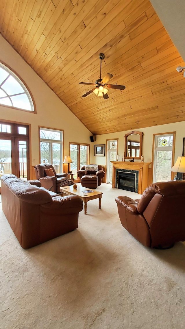 499 Tamarack Ct NE, Tenstrike, MN 56683 - living room with carpet, a glass covered fireplace, ceiling fan, wood ceiling, and high vaulted ceiling