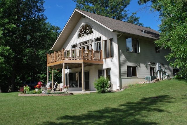 499 Tamarack Ct NE, Tenstrike, MN 56683 - back of house featuring a lawn, a wooden deck, a shingled roof, and central AC