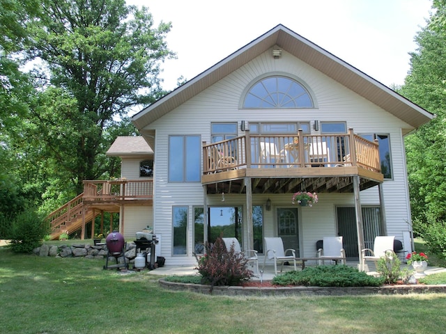 499 Tamarack Ct NE, Tenstrike, MN 56683 - rear view of house with a lawn, a wooden deck, and a patio area