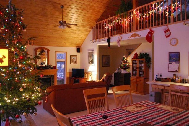 499 Tamarack Ct NE, Tenstrike, MN 56683 - dining room with wood ceiling, a ceiling fan, a fireplace, and high vaulted ceiling