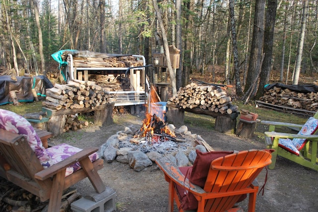 499 Tamarack Ct NE, Tenstrike, MN 56683 - view of patio / terrace featuring a fire pit and a forest view