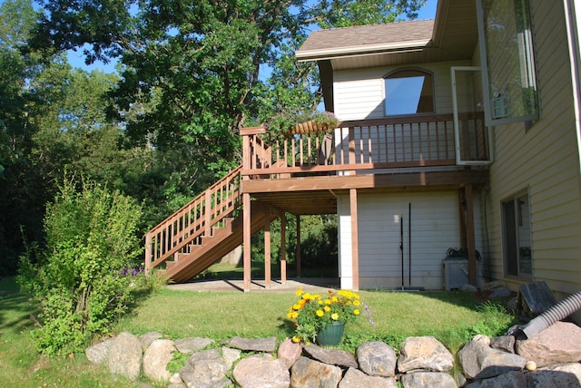 499 Tamarack Ct NE, Tenstrike, MN 56683 - back of house featuring a yard, a shingled roof, stairway, and a deck