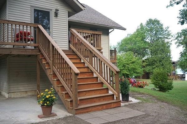 499 Tamarack Ct NE, Tenstrike, MN 56683 - view of exterior entry featuring a shingled roof and a wooden deck