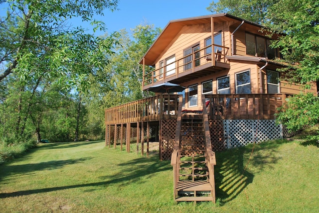 499 Tamarack Ct NE, Tenstrike, MN 56683 - back of house featuring a yard, a balcony, and a deck