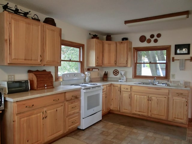 499 Tamarack Ct NE, Tenstrike, MN 56683 - kitchen featuring white electric range oven, a sink, light countertops, and light brown cabinetry