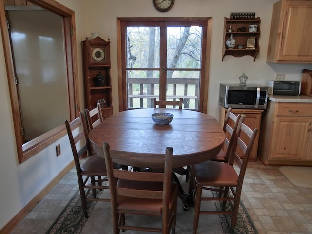 499 Tamarack Ct NE, Tenstrike, MN 56683 - dining room featuring stone finish floors and baseboards