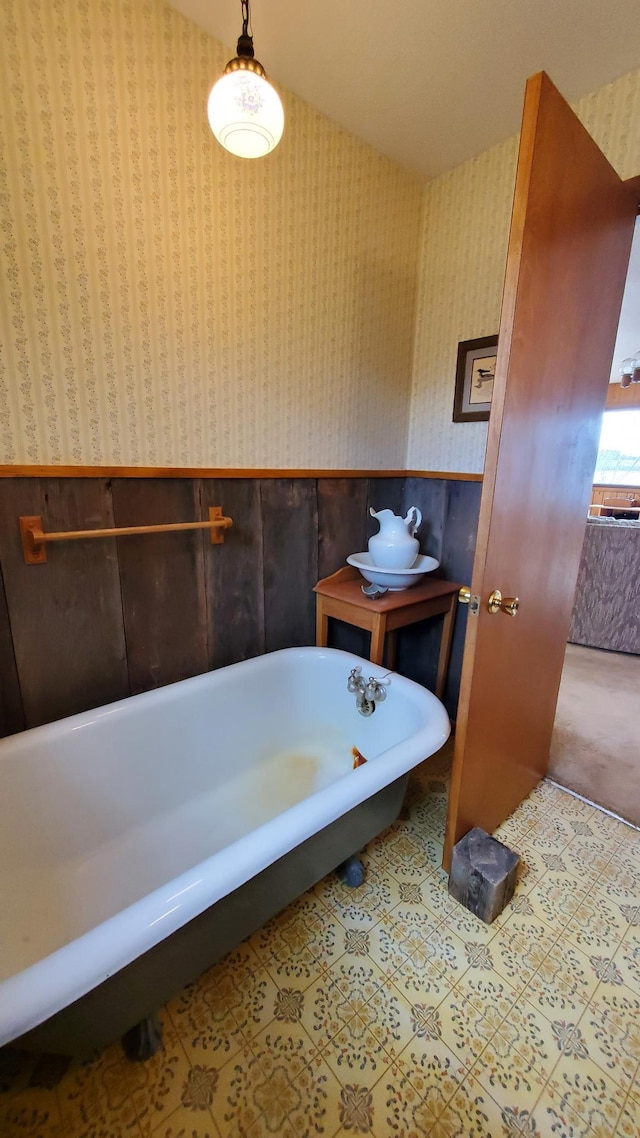 499 Tamarack Ct NE, Tenstrike, MN 56683 - bathroom featuring wainscoting, wallpapered walls, and a freestanding bath