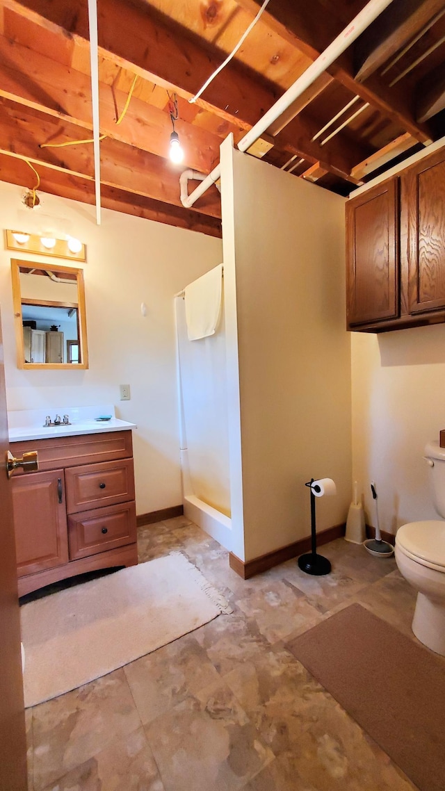 499 Tamarack Ct NE, Tenstrike, MN 56683 - full bath with a stall shower, toilet, vanity, and baseboards