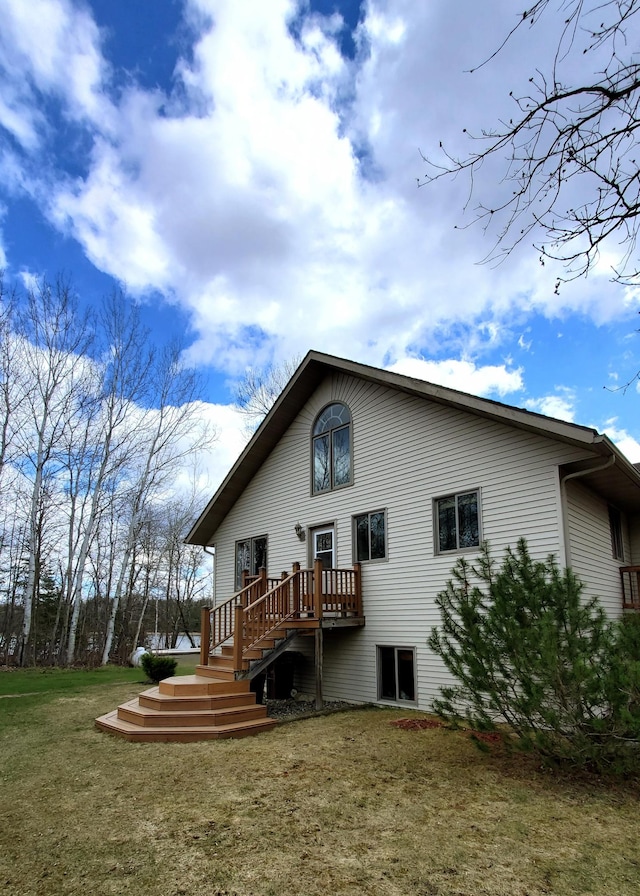 499 Tamarack Ct NE, Tenstrike, MN 56683 - back of property with a yard, a wooden deck, and stairs